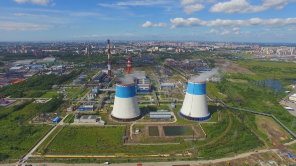 aerial view of power plant with large pipes on background of the city