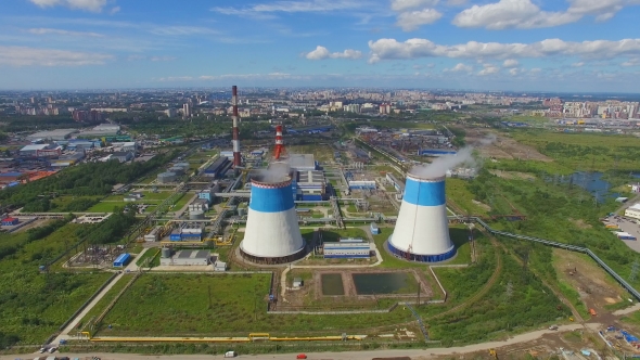 aerial view of power plant with large pipes on background of the city ...