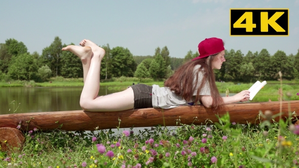 Young Girl Lying On a Bench And Reading a Book 3.
