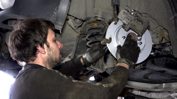Man Repair Automobile Brake System.