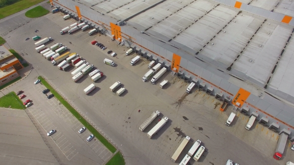Aerial view of the logistics warehouse with trucks waiting for loading