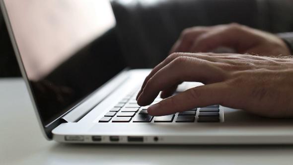 Man Typing On Laptop