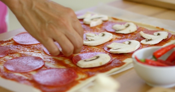 Woman Making a Delicious Pepperoni Pizza alt