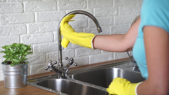 Woman Cleans Kitchen Surfaces