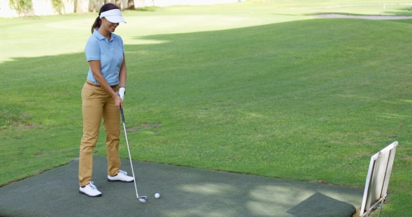 Young Female Golfer Preparing To Tee Off, Stock Footage | VideoHive