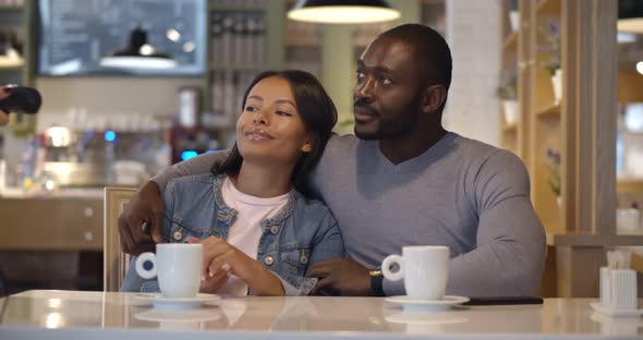 Afroamerican Man Paying Bill with Smartphone at Restaurant alt