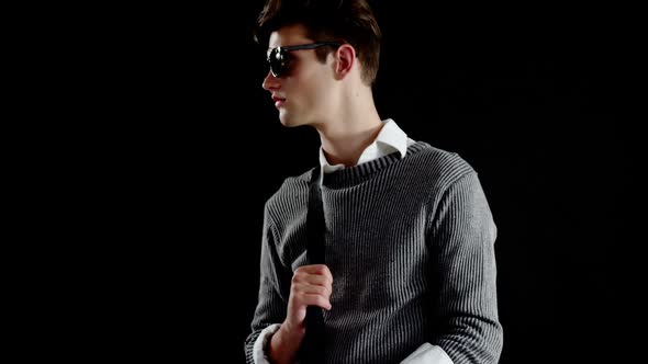 Androgynous man posing against black background alt