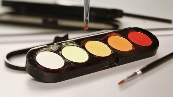 Makeup Brush Moving Over Multicolor Eye Shadows Palette