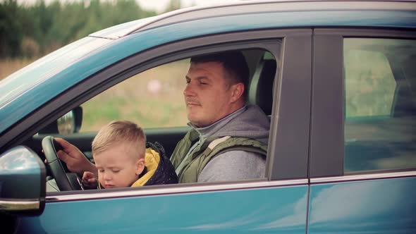 Little Sons Relaxing Carefree Father.  Family Cheerful Dad Playing Cute Little Child Boys On Park. alt