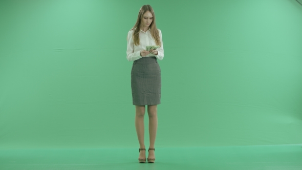 Business Woman Counts Money On Green Screen alt