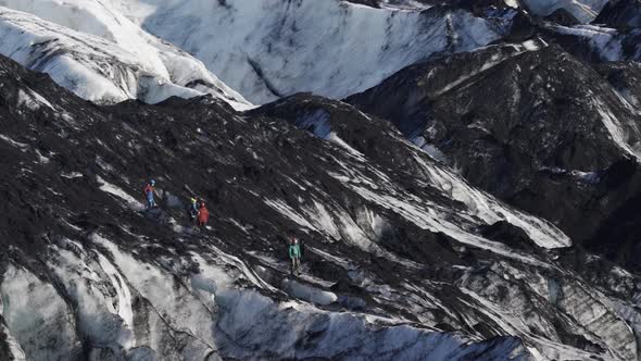Unrecognizable Tourist Groups Hiking Over Massive Glacier