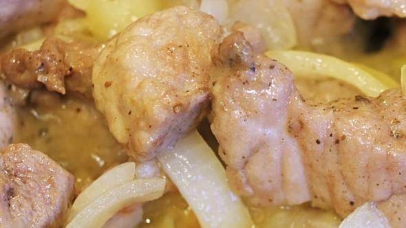 Pork Meat Pieces Roasted On Frying Pan With Onion, Sliding Video