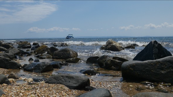Fancy Boat on a Rocky Beach in the Sea alt
