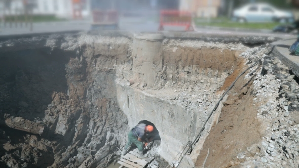Builder Repairing a Manifold Using Steel Disc Saw alt