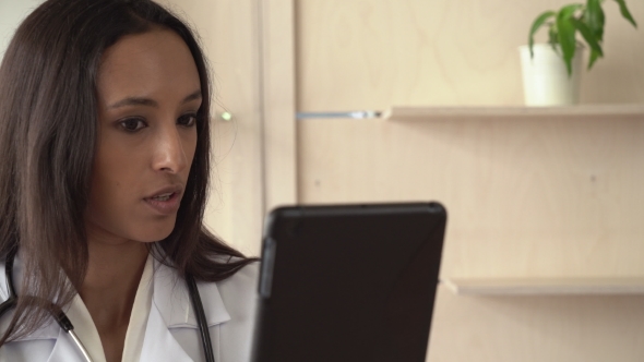 Professional Female Work As Physician Chatting Via Internet. alt