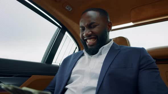Closeup Man Counting Money at Car. African Man Celebrating Victory at Vehicle alt