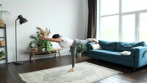 A Young Indian Woman Is Doing Yoga, Standing on One Leg Doing An Exercise for Balance alt