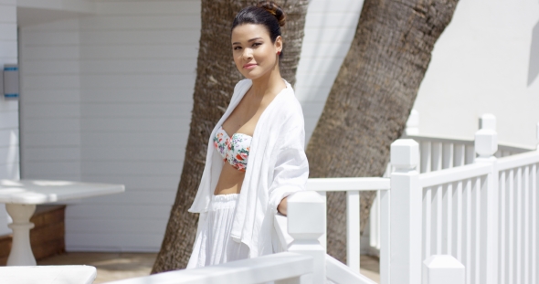Beautiful Woman Leaning On Fence Outside alt
