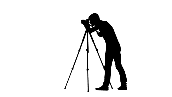 Operator Sets The Camera To a Tripod. Silhouette. White, Stock Footage