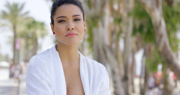 Calm Woman In White Robe Sitting Outdoors alt