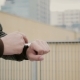 Man Using His Smartwatch Touchscreen Standing On The Roof, Then Walks Away. Hands .  - VideoHive Item for Sale