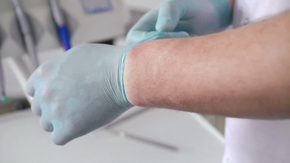 Clinic Therapist Taking Off Medical Gloves After Patient Examination, Healthcare