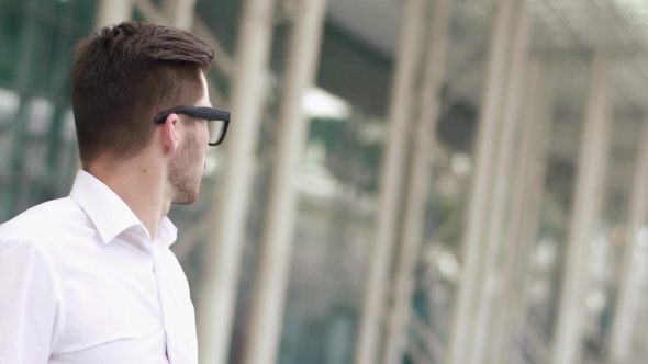 Of Handsome Businessman In White Shirt And Glasses Checking Time On Street While Waiting For