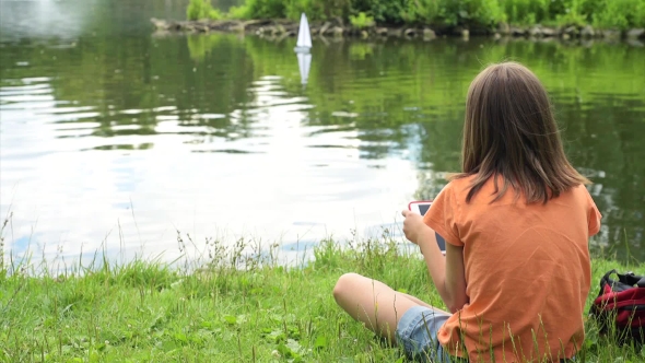 Girl With Remote Controlled Boat