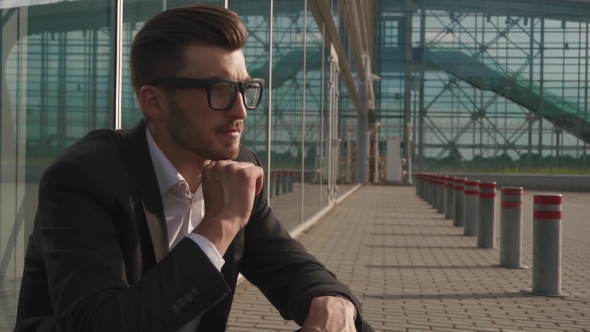 Portrait Of An Attractive Businessman In Glasses Being Worried And Thoughtful