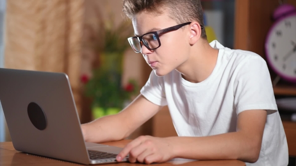 Teen Boy Working On Laptop