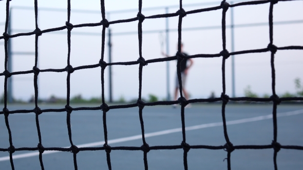 Tennis Player Volleys Using Forehand Technique. Tennis Net In Front alt
