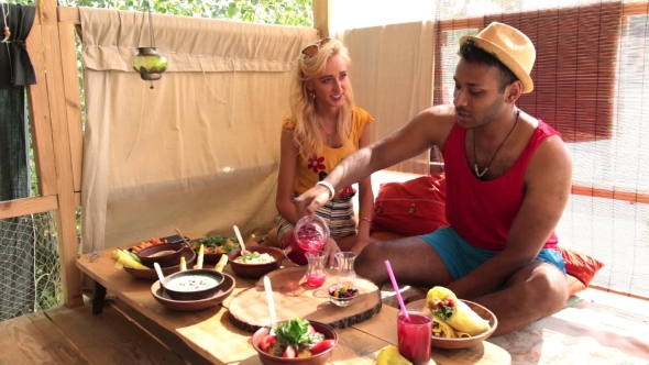 Couple Having a Lunch On Tree House At The Beach alt