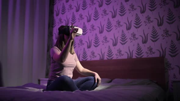 Woman Is Sitting in Bed in Virtual Reality 3d Glasses and Learning Something