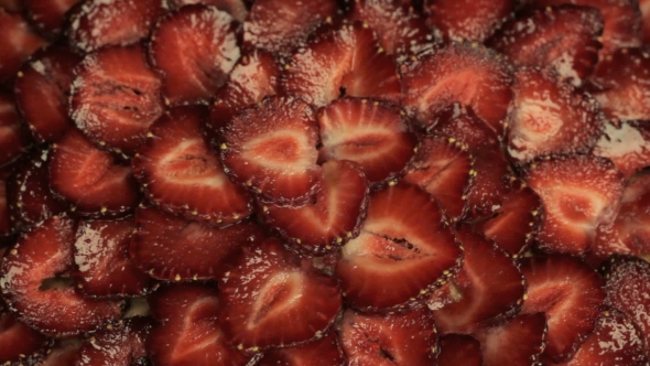 Red Slices Of Fresh Strawberries, Rapidly Rotates Counterclockwise alt