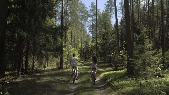 Young Couple Cycling In Nature