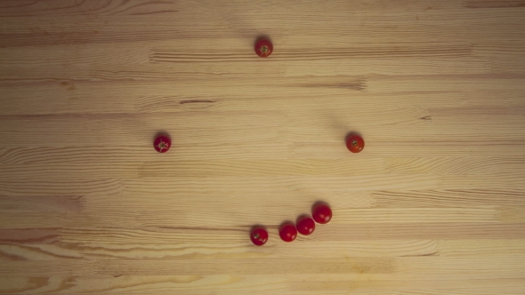 Cherry Tomatoes Forming a Moving Clock On Wooden Surface
