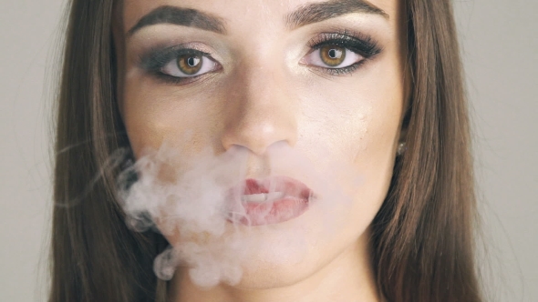  Woman Mouth Blow Fume On Background alt