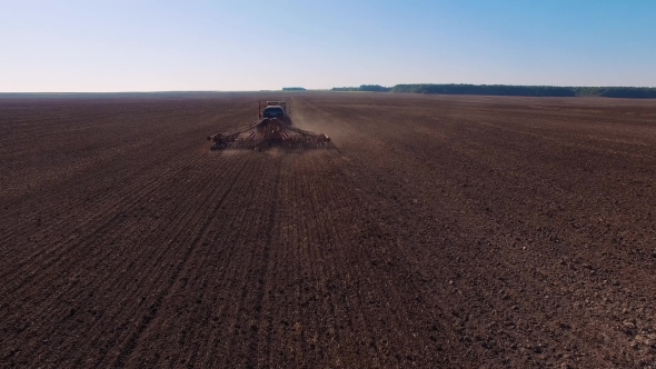  Aerial Footage Of a Modern Tractor Plowing Dry Field, Preparing Land For Sowing