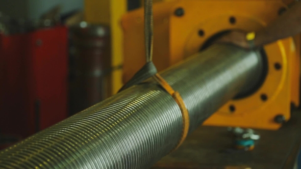 Man With Watch on Hand, Maintains Suspended Metal Pipe
