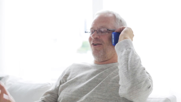 Happy Senior Man Calling On Smartphone At Home 22 alt