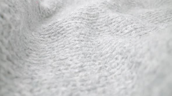Extreme detail view of sheep wool cloth texture flowing in macro dolly shot. alt