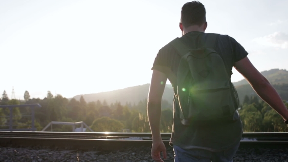 Young Couple Walking And Huging Together On Old Railroad In Mountains alt