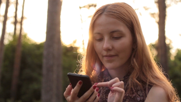 Red-haired Young Girl Using Cell Phone