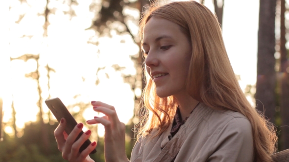 Red-haired Girl Using Mobile Phone