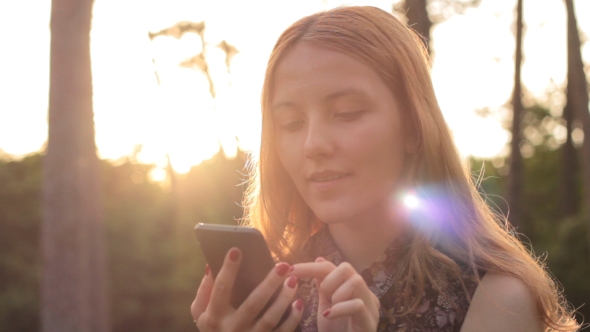 Red-haired Young Girl Using Cell Phone