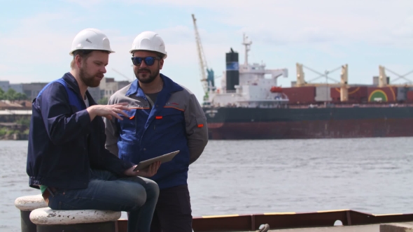 Two Engineers With Laptop Smile And Communicate In Shipping Cargo Port alt
