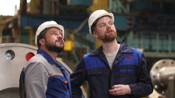 Two Engineers Discuss Important Stages Of Construction In Heavy Industry Factory alt