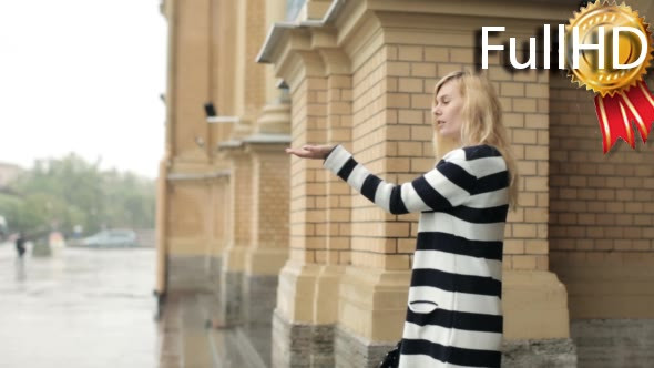 Young Girl With an Umbrella Walking in Heavy Rain alt