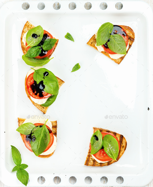 Caprese sandwiches with tomato, mozzarella cheese, basil and balsamic glaze - Stock Photo - Images