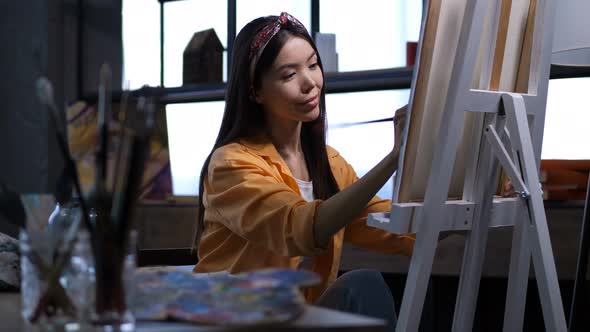 Female Artist Making a Painting at Art Studio alt
